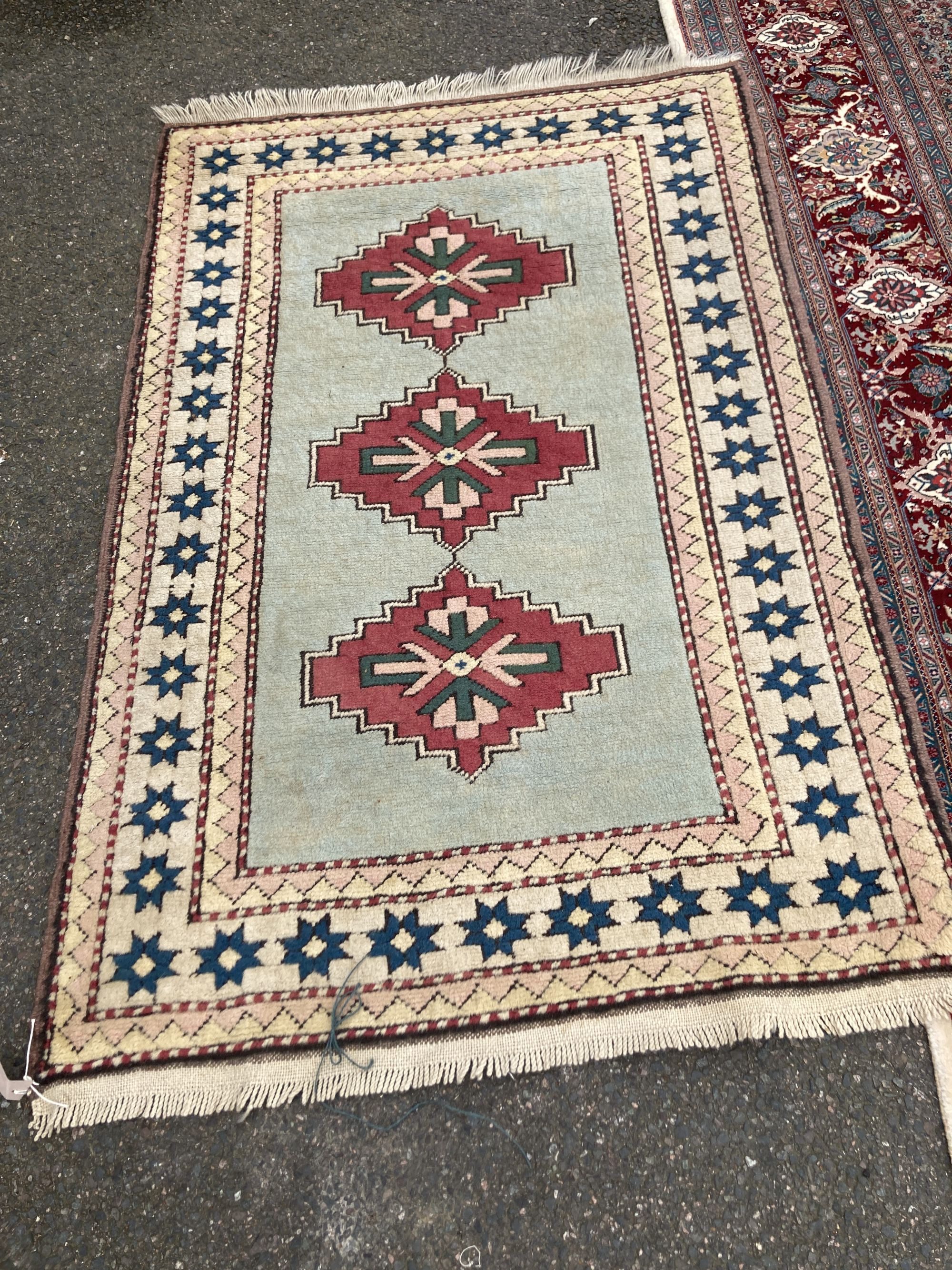 A Chinese Tabriz style carpet having burgundy central medallion on a foliate ivory ground, and a small Turkish rug